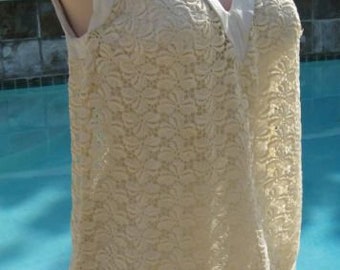 May include: A white lace sleeveless top with a white v-neck and a white skirt. The top is made of delicate lace and the skirt is a simple, solid white.