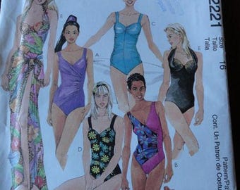 May include: McCall's sewing pattern for swimsuits. The pattern features illustrations of various swimsuit designs, including one-piece suits and a wrap. The cover has the text "Suit Yourself" and the pattern number 2221.