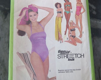 May include: Simplicity sewing pattern number 9002 for a swimsuit. The pattern includes instructions for three sizes: 8, 10, and 12. The pattern is for stretch knit fabric and includes a time-saver stretch knit rule.