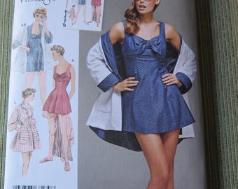 May include: A vintage Simplicity sewing pattern featuring a 1950s design. The pattern packet displays a woman in a blue polka-dot dress with a bow, and a white jacket. The pattern number is 8139, with sizes 14-22.