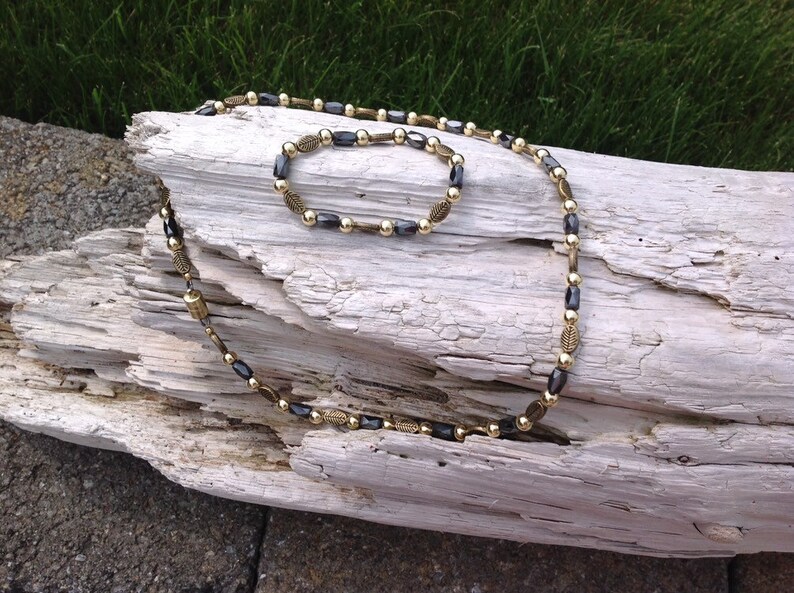 Magnetic Hematite Tube Bead Necklace with Deep Gold Leaf Embossed Accents and Gold Metal Beads
