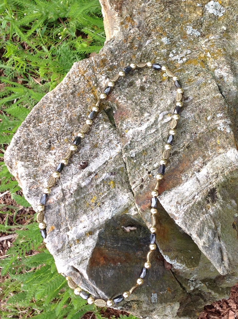 Magnetic Hematite Tube Bead Necklace with Deep Gold Leaf Embossed Accents and Gold Metal Beads