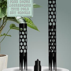 May include: Black plant support poles with a honeycomb design and a small accessory. The poles have a forked base for easy insertion into soil. The image includes text that reads "FREE BONUS ACCESSORIES WITH POLE SET ORDERS."