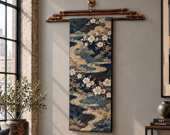 May include: A vertical wall hanging tapestry featuring a dark blue background with gold, cream, and white floral and flowing water patterns. The textile is suspended from a horizontal dark brown bamboo rod with a brass mounting fixture.