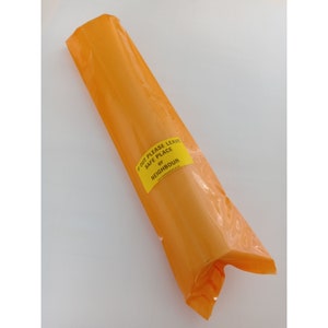 May include: A bright orange plastic bag with a yellow label that reads "If out please leave safe place or neighbour".