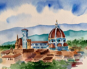 Puede incluir: Pintura acuarela del Duomo de Florencia, Italia. La pintura representa la icónica cúpula de la catedral, rodeada de otros edificios y una cordillera en el fondo. El cielo es azul claro con nubes blancas.