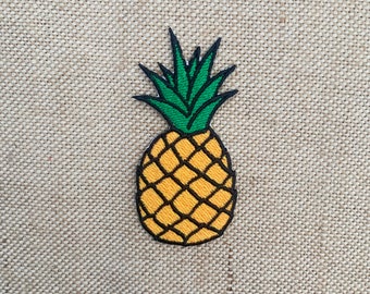 May include: A yellow and green embroidered pineapple patch. The pineapple is outlined in black and has a detailed design.