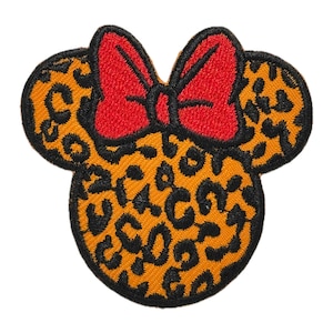May include: A yellow and black leopard print iron-on patch in the shape of a cartoon mouse head with a red bow.