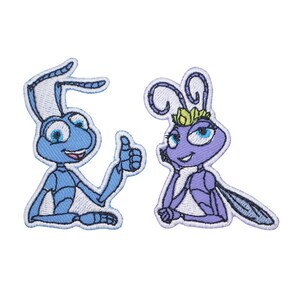 May include: Two embroidered patches featuring characters from the animated film A Bug's Life. The first patch is a blue ant with a friendly smile and a thumbs up. The second patch is a purple bug with a crown and a friendly smile.