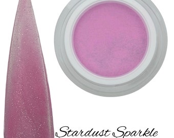 Könnte beinhalten: Ein kleines Glas mit rosa Glitzer-Nagelpulver mit einem leichten rosa Schimmer. Das Glas ist mit "Stardust Sparkle" beschriftet.