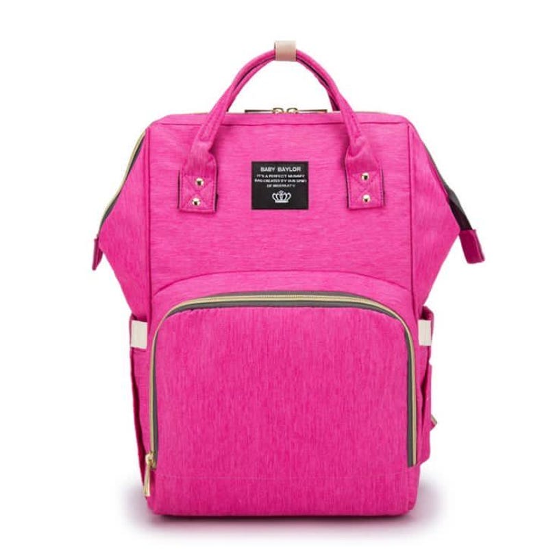 May include: A pink diaper bag backpack with gold accents and a zippered pocket on the front. The bag has a label that says "Baby Baylor It's a perfect mommy bag for all your baby's needs".