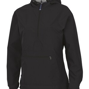 May include: Black anorak jacket with a hood and a half-zip. The jacket has a front pocket with a zip and elasticated cuffs. The hood's interior is grey. The brand name "CHARLES RIVER" is printed on a small tag on the zip.