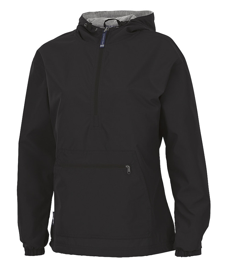 May include: Black anorak jacket with a hood and a half-zip. The jacket has a front pocket with a zip and elasticated cuffs. The hood's interior is grey. The brand name "CHARLES RIVER" is printed on a small tag on the zip.