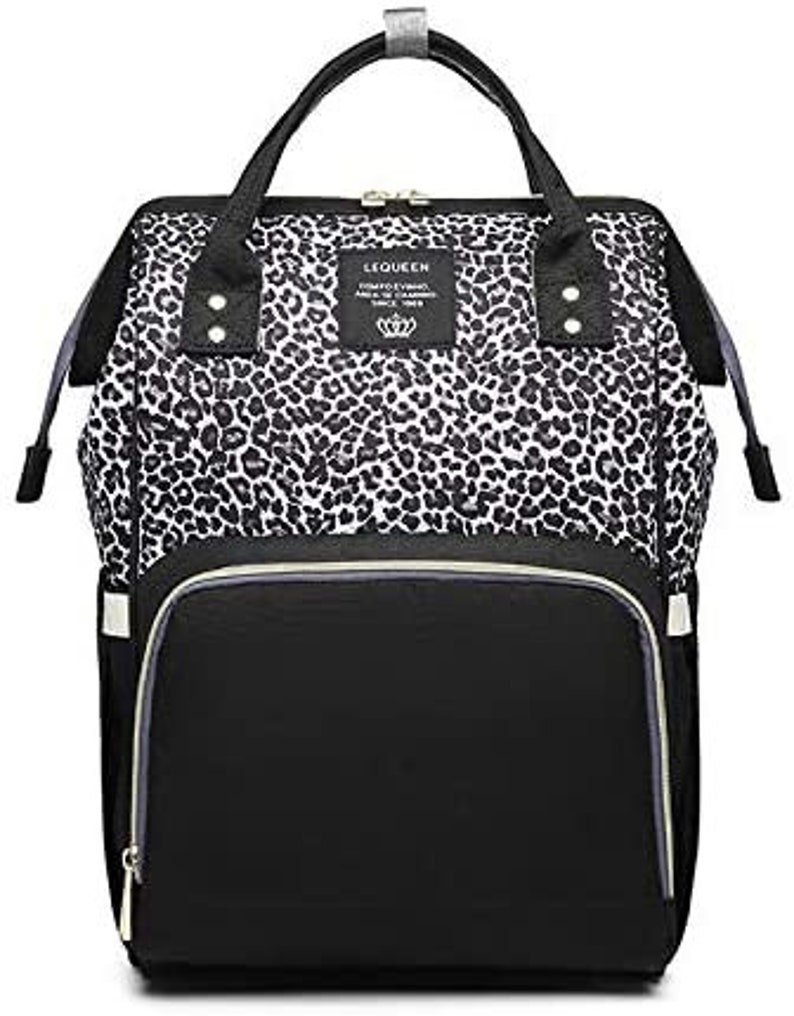 May include: Black and white leopard print diaper bag with a black zippered front pocket and the text "LEQUEEN COMFORT YOUR LIFE SINCE 1988" on a white tag.