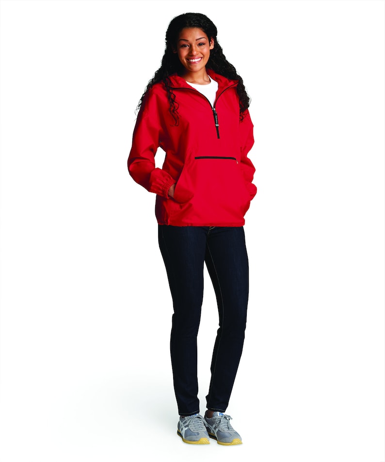 May include: A red hooded jacket with a zipper closure and a large front pocket. The jacket has a black zipper and black trim around the hood and pockets.