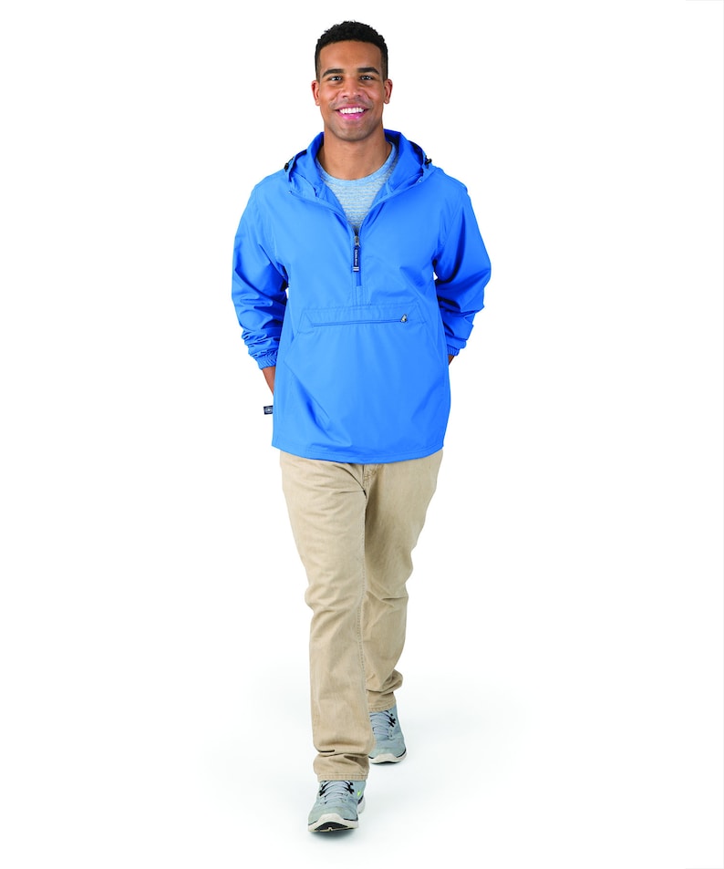 May include: A light blue pull-over jacket with a zipper and a kangaroo pocket. The jacket has a hood and is made of a water-resistant material.