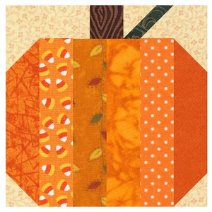 May include: A patchwork pumpkin quilt block with orange, brown, and white fabric. The pumpkin is made up of vertical strips of fabric with different patterns, including candy corn, leaves, and polka dots.