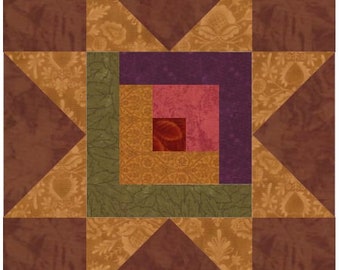 May include: A quilt block with a star design in the center. The star is made up of five triangles in shades of brown, gold, and green. The center of the star has a smaller square design with a series of squares in shades of purple, pink, and red.