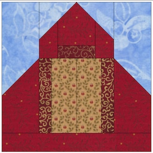 May include: A red and gold quilt block with a house design. The house has a red roof, a gold door, and a brown window. The background is blue.
