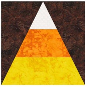 May include: A colorful, geometric design resembling a candy corn. The design features a white triangle at the top, followed by an orange section, and a yellow base. The background is a mottled brown.