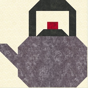 May include: A gray and black teapot with a red lid. The teapot has a spout and a handle.