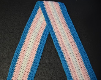 May include: A crocheted strap with blue, white, and pink stripes. The strap is folded in half, creating a V-shape.
