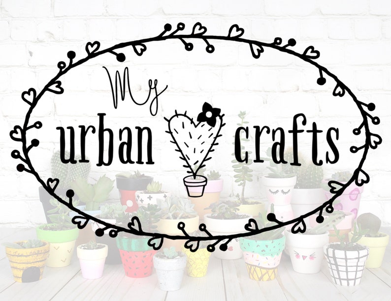 May include: A black and white illustration of a cactus with a heart shape and a flower on top. The text "My urban crafts" is written in a cursive font above the cactus. The image is surrounded by a wreath of hearts and leaves. There are many small painted flower pots in the background.