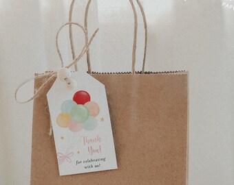 May include: A brown paper gift bag with a thank you tag attached. The tag has a colorful illustration of balloons and the text "Thank You! for celebrating with us!"