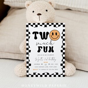 May include: A black and white checkered birthday party invitation with a yellow smiley face and the text "Two much fun". The invitation is for Wyatt's 2nd birthday party on March 12th from 2:00 to 4:00 at 1234 Garden Lane, Portland. RSVP to Sarah at 123.456.7890.