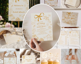 May include: A collection of bridal shower stationery and decorations with a honeybee theme. Includes invitations, signage, recipe cards, cupcake toppers, and champagne bottles. The design features gold accents and the text "She Found Her Honey".