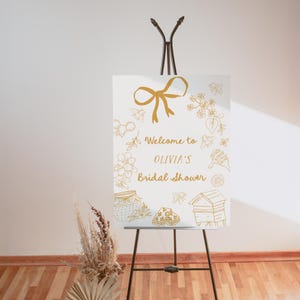 Editable bridal shower welcome sign featuring hand-drawn honey bees, honey jars, and a yellow bow. Perfect for a Bride to Bee or She Found Her Honey themed wedding shower.