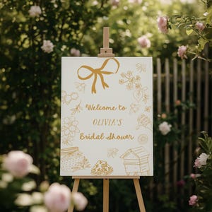 Editable bridal shower welcome sign featuring hand-drawn honey bees, honey jars, and a yellow bow. Perfect for a Bride to Bee or She Found Her Honey themed wedding shower.