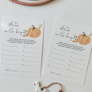 Peut inclure: Deux cartes de jeu imprimables sur le thème de l'automne. Les cartes présentent une illustration de citrouille et le texte "what's in the bag". Les cartes comportent dix lignes pour écrire des devinettes et un espace pour écrire le nombre total de réponses correctes.