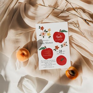 Apple baby shower invitation with hand-drawn red apples and florals, an editable apple of our eye baby shower template with a sweet, neutral style.