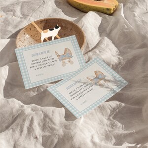 Blue gingham baby shower invitation set featuring a vintage baby carriage illustration, soft baby boy colors, and classic traditional styling. Editable baby shower bundle with coordinated invitation, books for baby card, diaper raffle ticket, and thank you card for an elegant and timeless celebration.