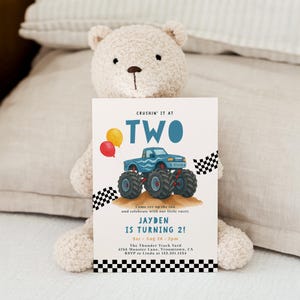 May include: A birthday invitation featuring a blue monster truck with large tires, red and yellow balloons, and the text "CRUSHIN' IT AT TWO." The invitation also includes the text "JAYDEN IS TURNING 2!" and event details.