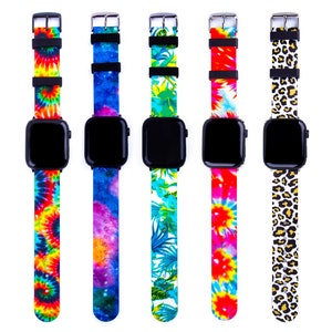 May include: Five smartwatches with black square faces and colorful bands. The bands feature tie-dye, galaxy, floral, and leopard prints. Each watch has a black buckle and black strap holders.