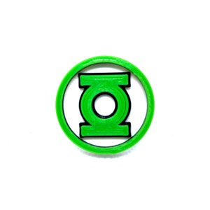 May include: Green Lantern logo printed in green and black on a white background. The logo is a circle with a green symbol inside.