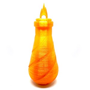 May include: A gold-colored, 3D printed bottle with a flame-shaped top. The bottle has a textured, swirling design.