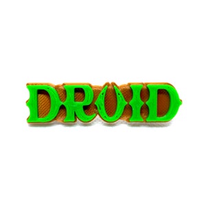 May include: A green 3D printed word "DRUID" with a brown outline.