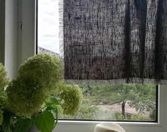 May include: A white straw hat with a black band sits on a windowsill, with a potted plant and a black linen curtain in the background.