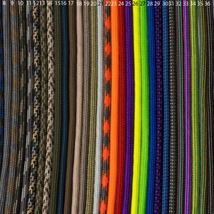 May include: A collection of 43 different colors and patterns of paracord, a type of strong nylon cord often used for crafting and survival.
