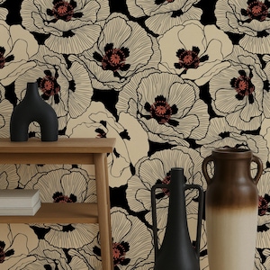 May include: A decorative interior scene featuring a wooden shelf with a black vase and a stack of white books. The background is a floral wallpaper with large cream-colored poppy flowers with black outlines and red centers.
