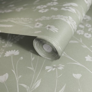 May include: A roll of green wallpaper with a white floral pattern. The wallpaper features a delicate design of white flowers and leaves on a sage green background.