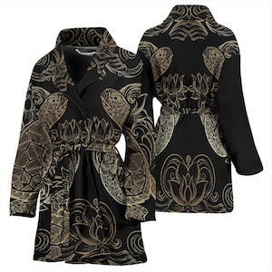 May include: A black and gold robe with a floral and turtle design. The robe has a shawl collar and a tie belt.