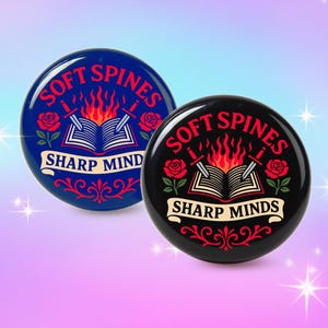 May include: Two round buttons with the text "SOFT SPINES" above an open book with flames, and "SHARP MINDS" below. One button is blue with red accents, the other is black with red accents. Both have rose and sword illustrations.