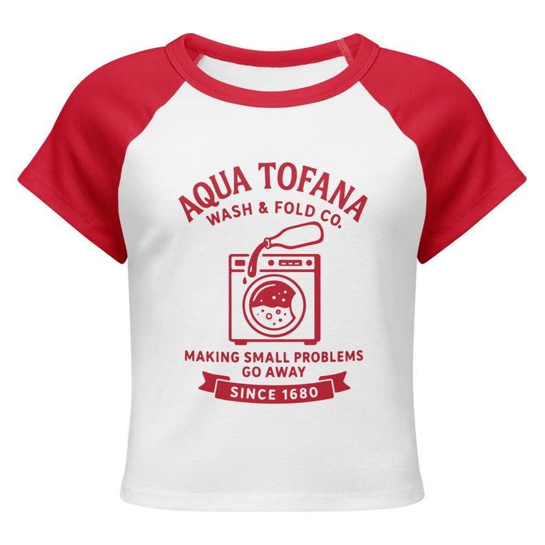 A women's fitted, mid-length micro rib raglan baby tee. The tee's body is solid white, made from a 1x1 micro-rib fabric.  It features short, set-in sleeves and a crewneck collar binding in a bold, contrasting athletic red. Centered on the chest is a vintage-inspired graphic printed in the same red ink. The design is for the "Aqua Tofana Wash & Fold Co." and features an illustration of an old-fashioned washing machine. Text below the machine reads "Making small problems go away" and "Since 1680."