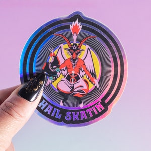 Sticker featuring a holographic design of a rollerskating goat figure inspired by Baphomet, holding a roller skate. The text 'Hail Skatin' appears below, blending rebellious skate culture with occult symbolism in a bold and edgy style.