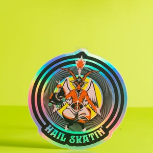 Vibrant 'Hail Skatin'' sticker featuring a colorful goat demon with roller skates, embodying a quirky mix of satanic and skate culture. Perfect for adding some edgy flair to your belongings.