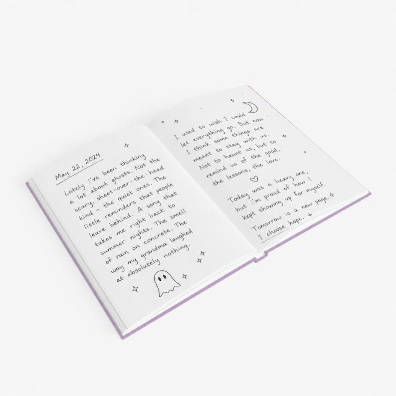 A 5 by 7 inch hardcover journal with a matte pastel purple cover and black printed graphics. The front features a retro inspired illustration of a white ghost character. One design shows the ghost holding a locked book flanked by a lit candle and a skeleton key with text reading Notes For My Future Ghost. The other shows the ghost peeking over a blank label with text reading Property Of The Future Ghost. Both include crescent moons, four point stars, and vintage decorative border frames.